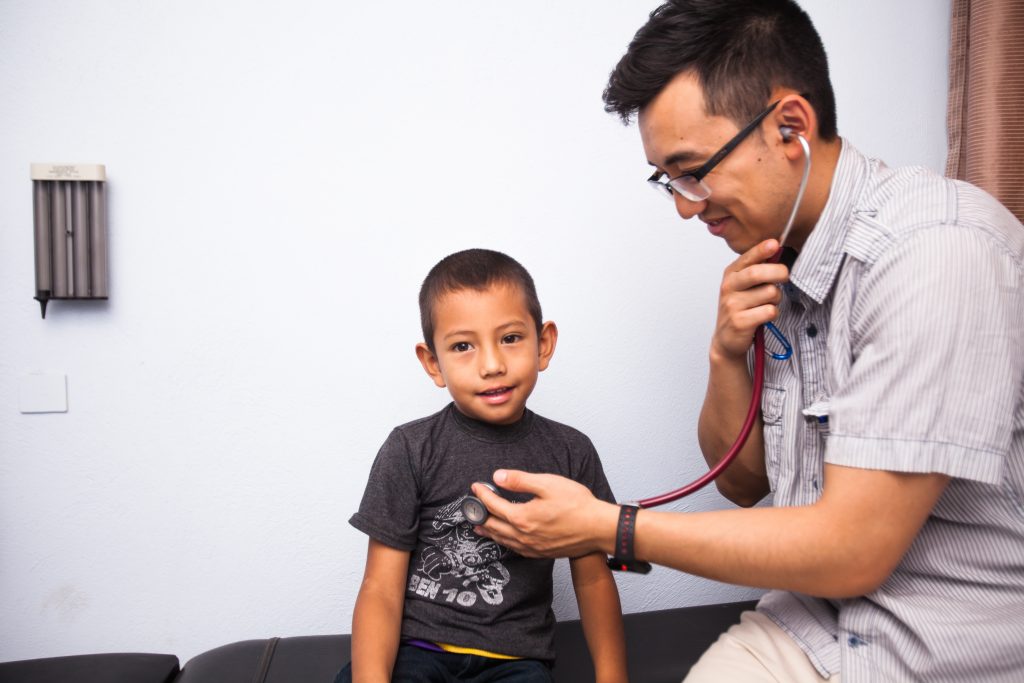 Doctor examining young patient